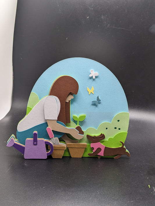 Horticultural Harmony: Crafted Cardstock Spring Birthday Card with Gardener and Pet